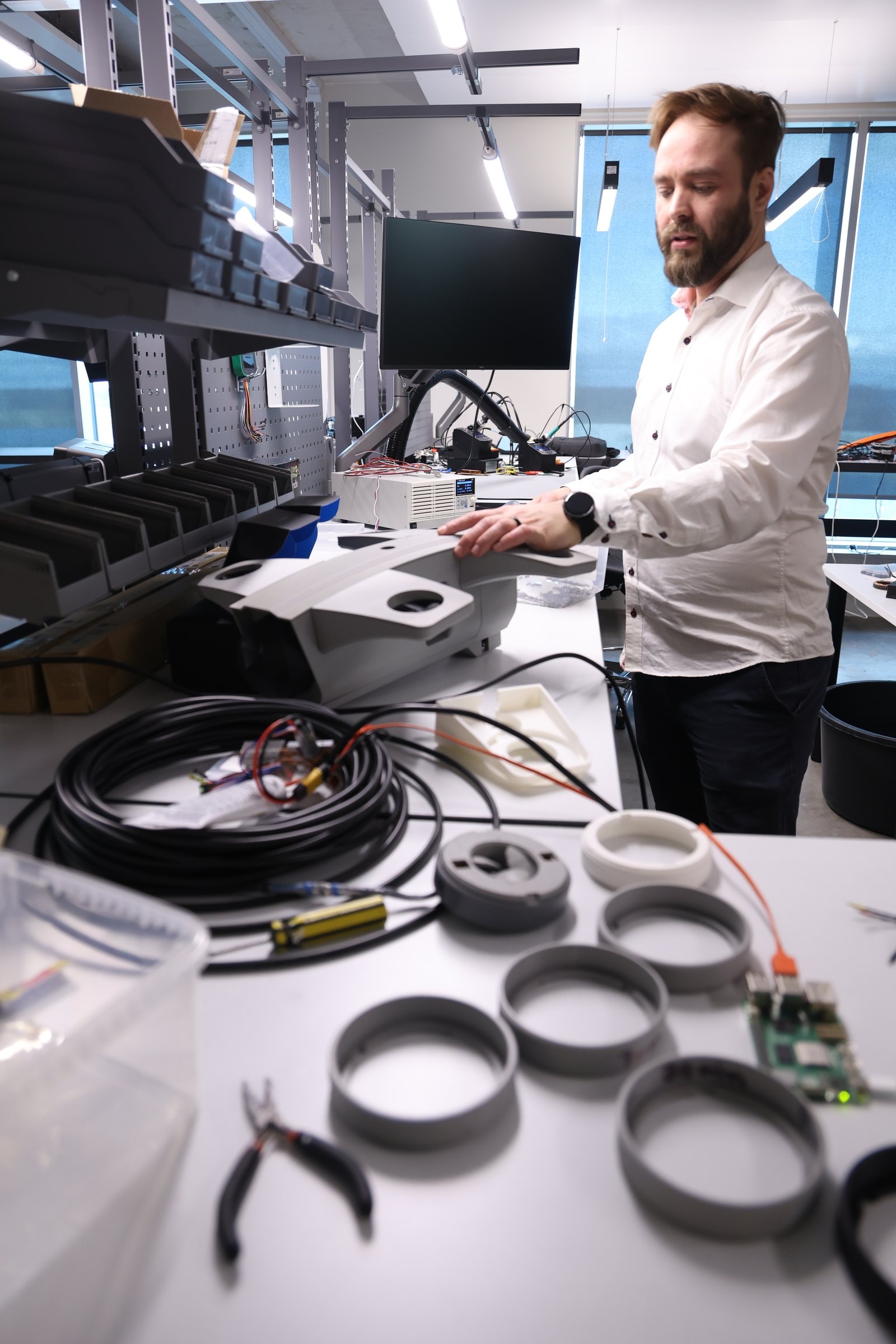 Engineer at a Lab workbench with prototype parts and wiring