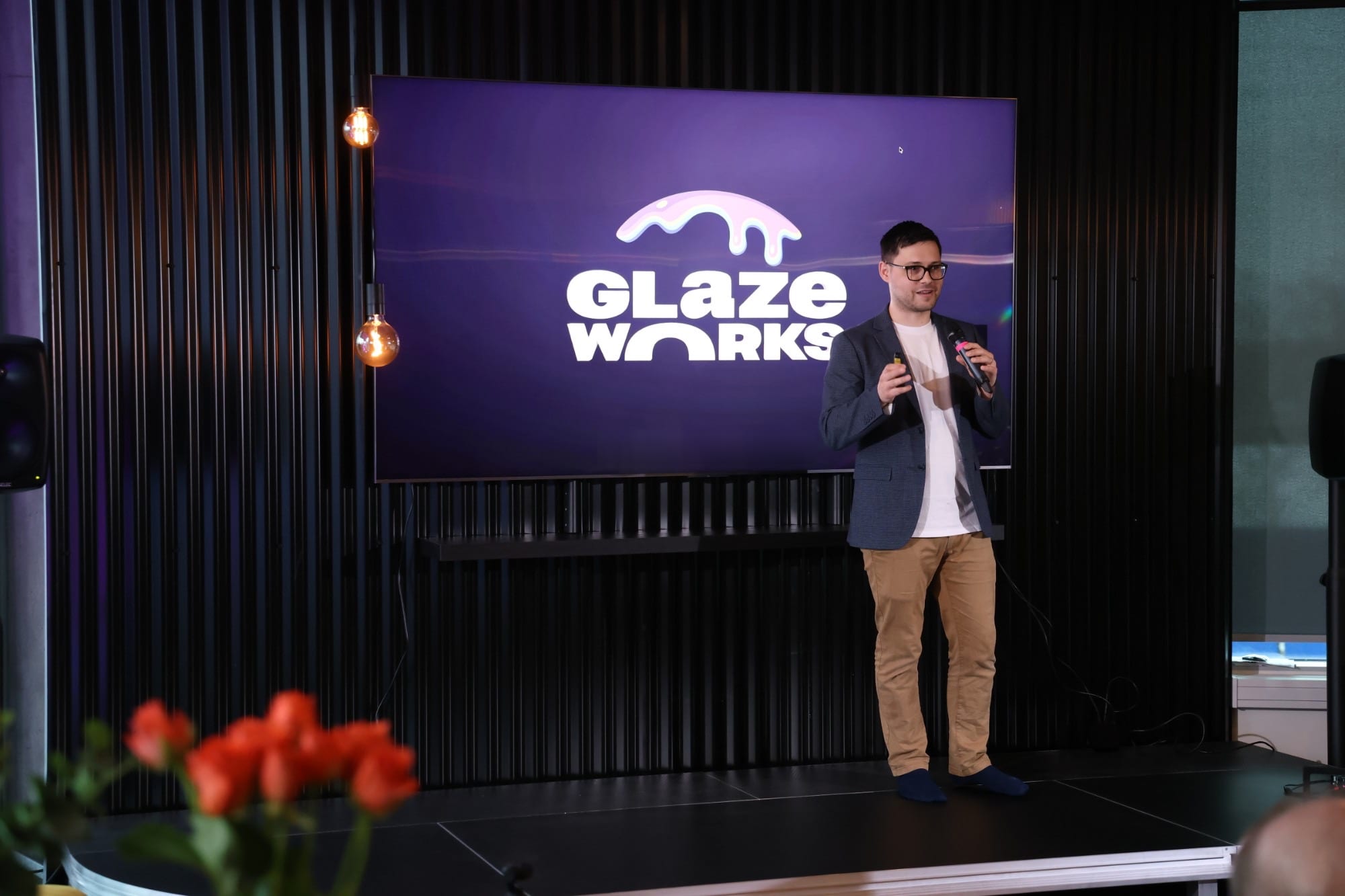 Speaker introducing Glazeworks on stage in the Office